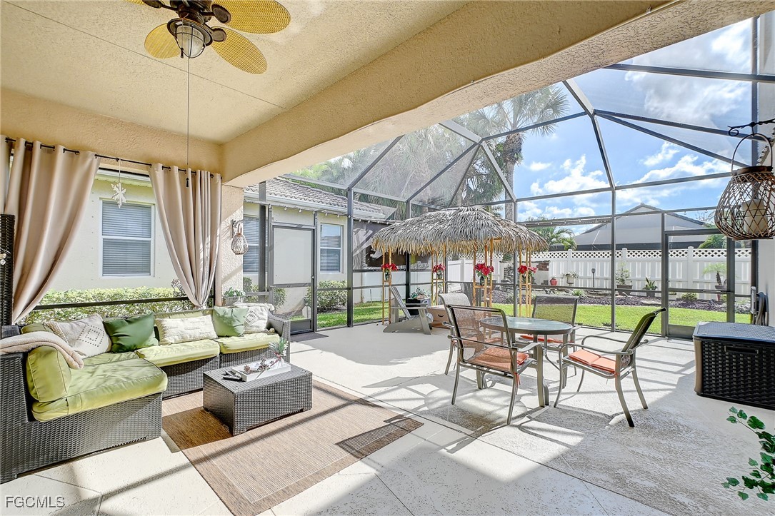12890 Timber Ridge Drive Fort Myers, FL 33913 - Photo 3 of 39 a dining room with furniture a chandelier and a rug