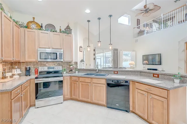a kitchen with stainless steel appliances granite countertop a sink stove and cabinets