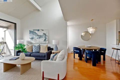 a living room with furniture piano and a large window