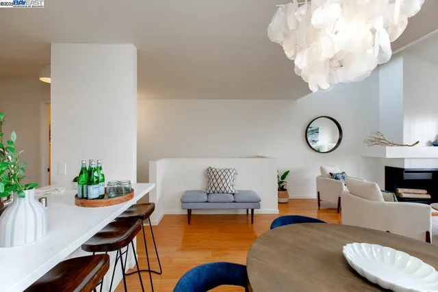 a living room with furniture a chandelier and a dining room