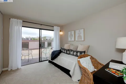 a bedroom with a bed and a couch