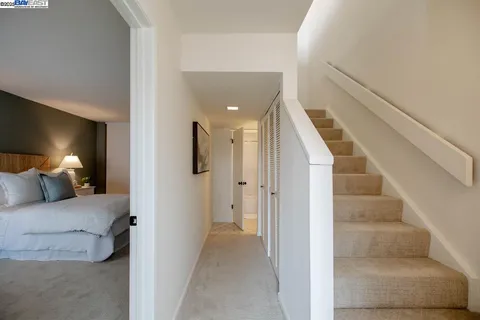 a view of a bedroom with a bed and lamp