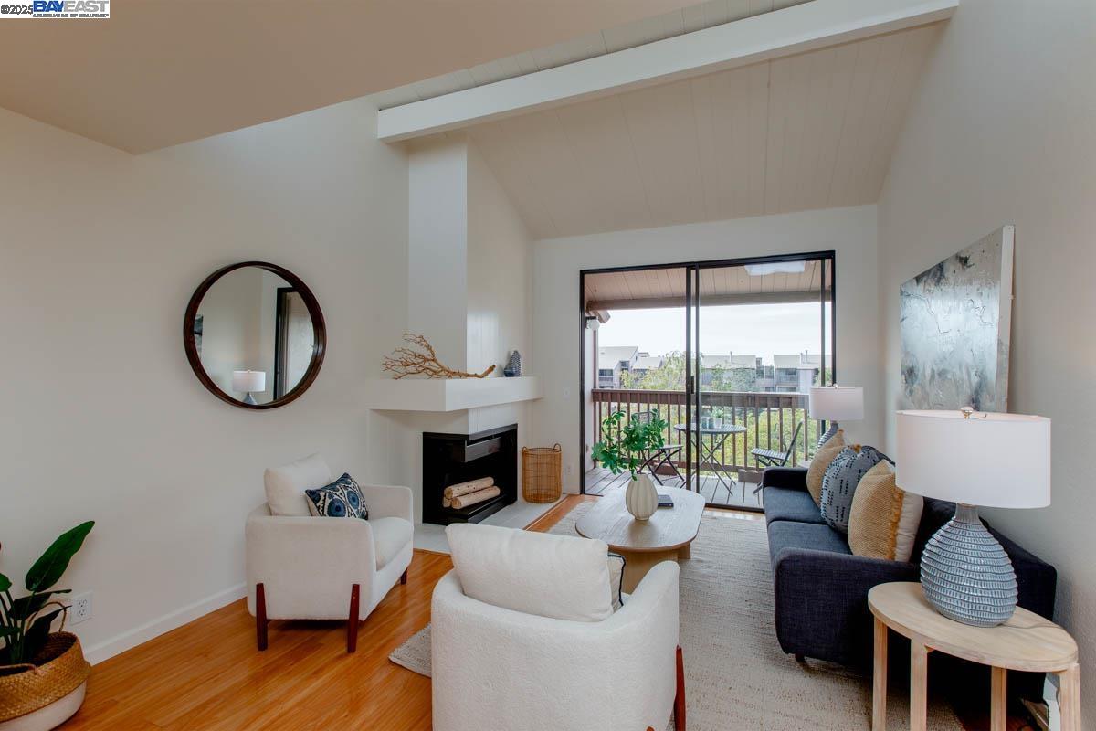 2101 Shore Line Drive, Unit 475 Alameda, CA 94501 - Photo 7 of 37 a living room with furniture large window and a fireplace