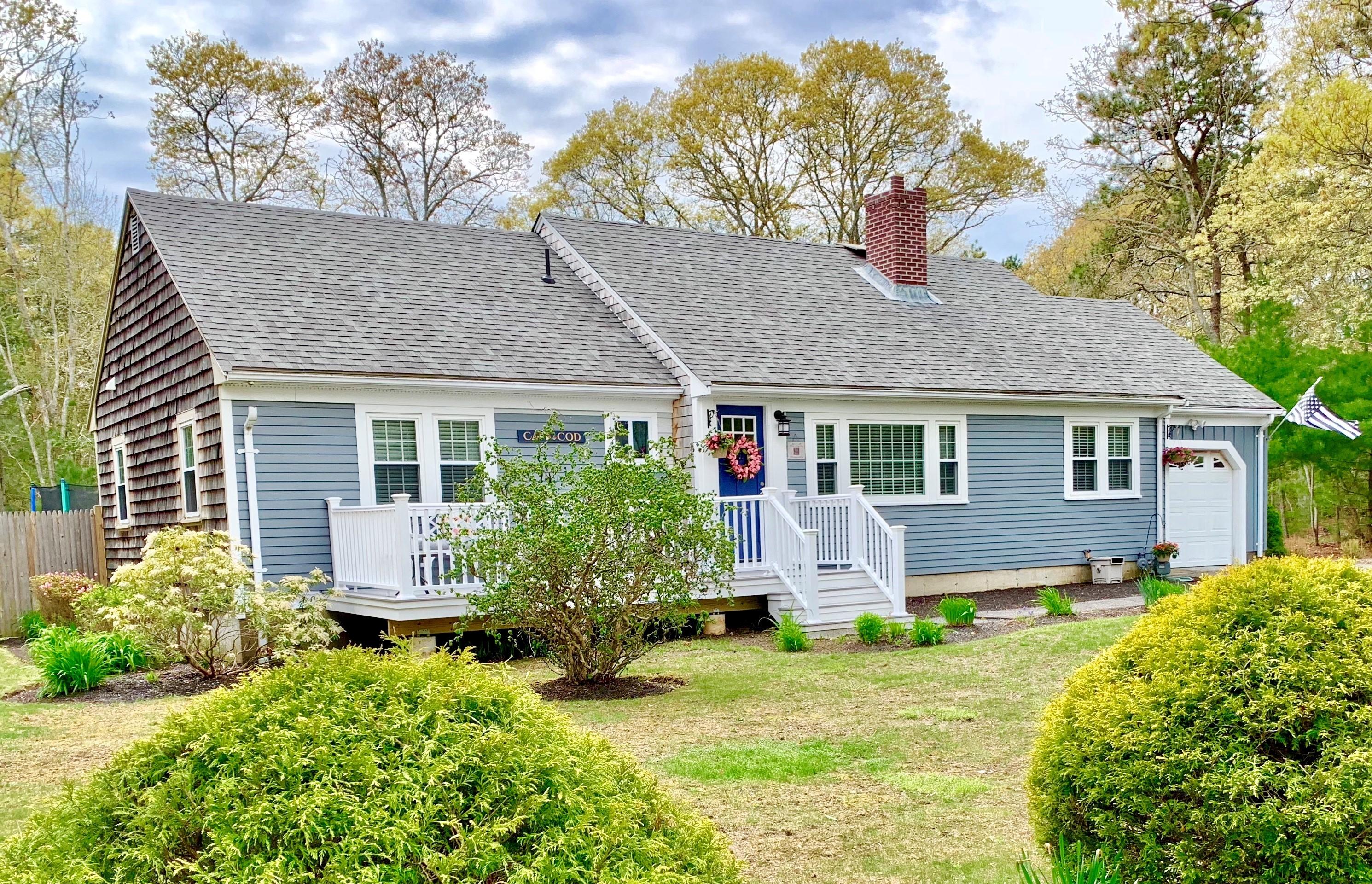 57 Anchor Lane Cotuit, MA 02635 - Photo 2 of 29 a front view of a house with garden