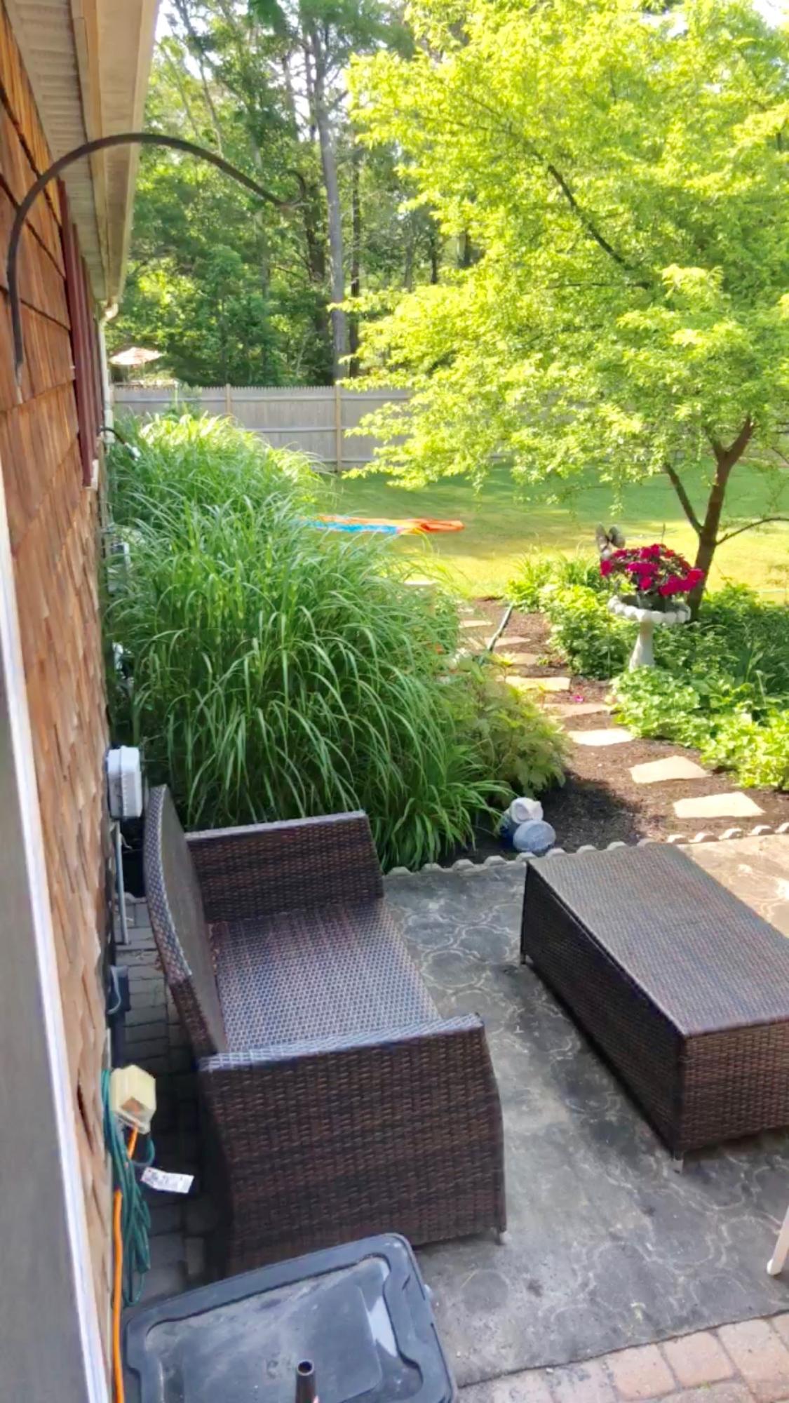 57 Anchor Lane Cotuit, MA 02635 - Photo 25 of 29 a view of a backyard with plants and outdoor seating