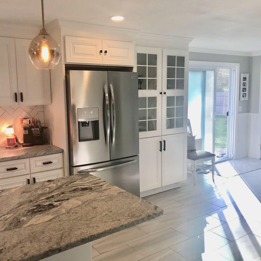 57 Anchor Lane Cotuit, MA 02635 - Photo 4 of 29 a kitchen with granite countertop a refrigerator and a stove top oven