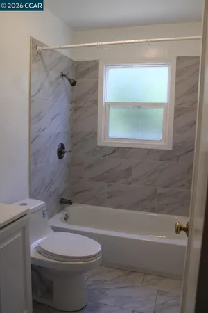 a bathroom with a toilet and a bathtub