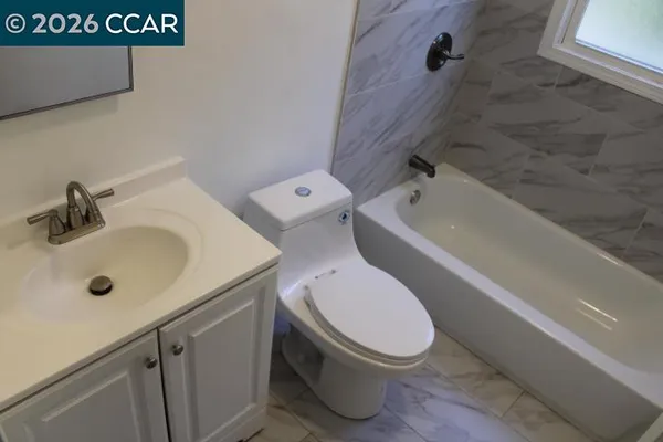 a bathroom with a sink a toilet and bathtub