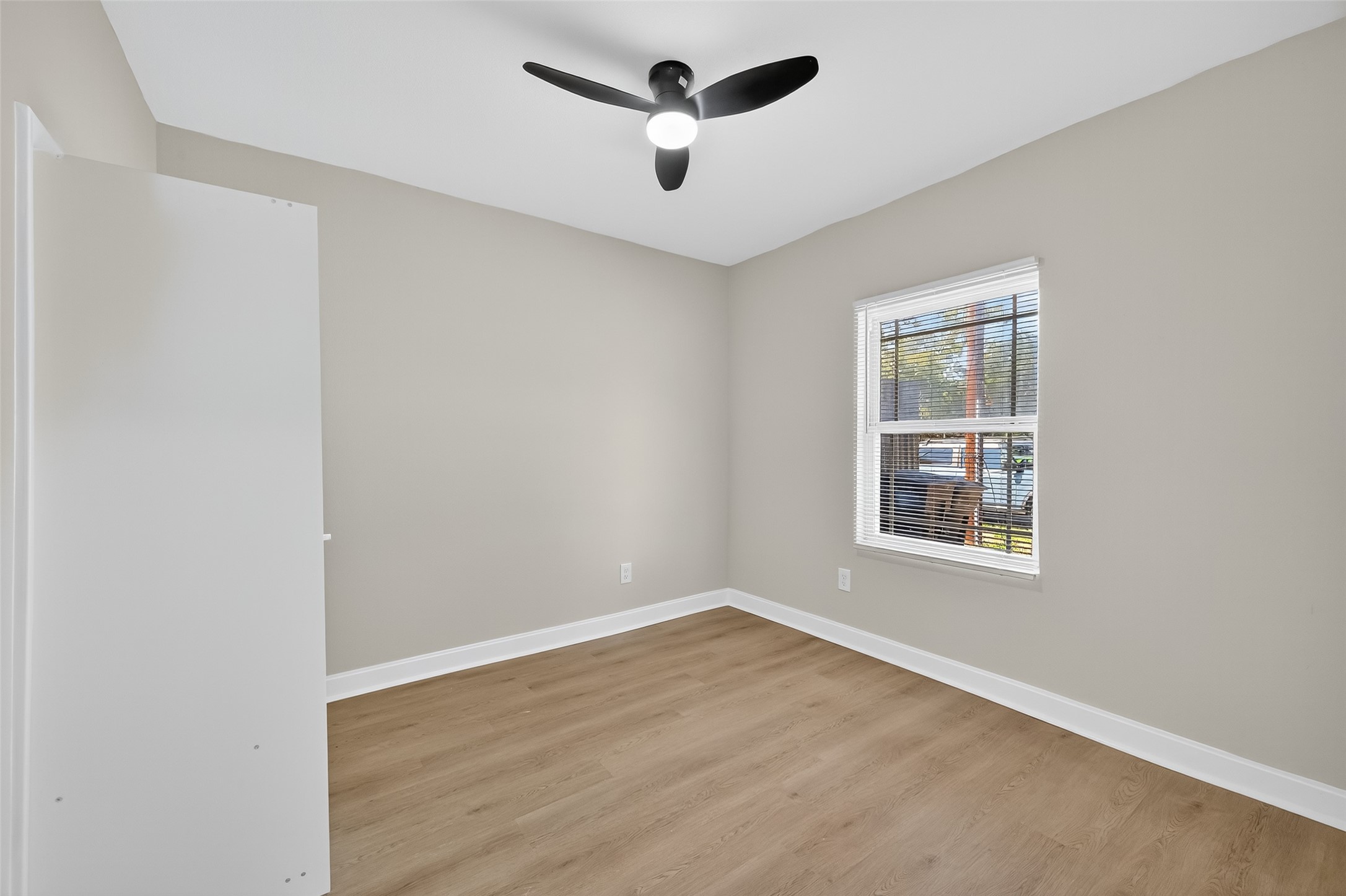 889 Chas Lane Houston, TX 77091 - Photo 15 of 32 an empty room with a window and a fan