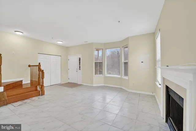 a view of an empty room with a fireplace