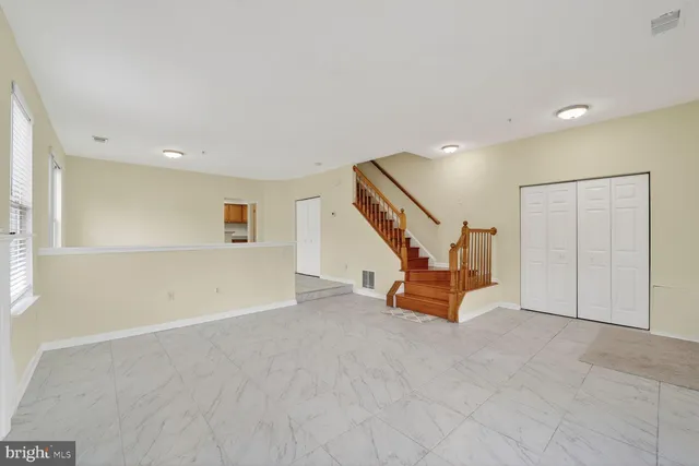 a view of an empty room with stairs
