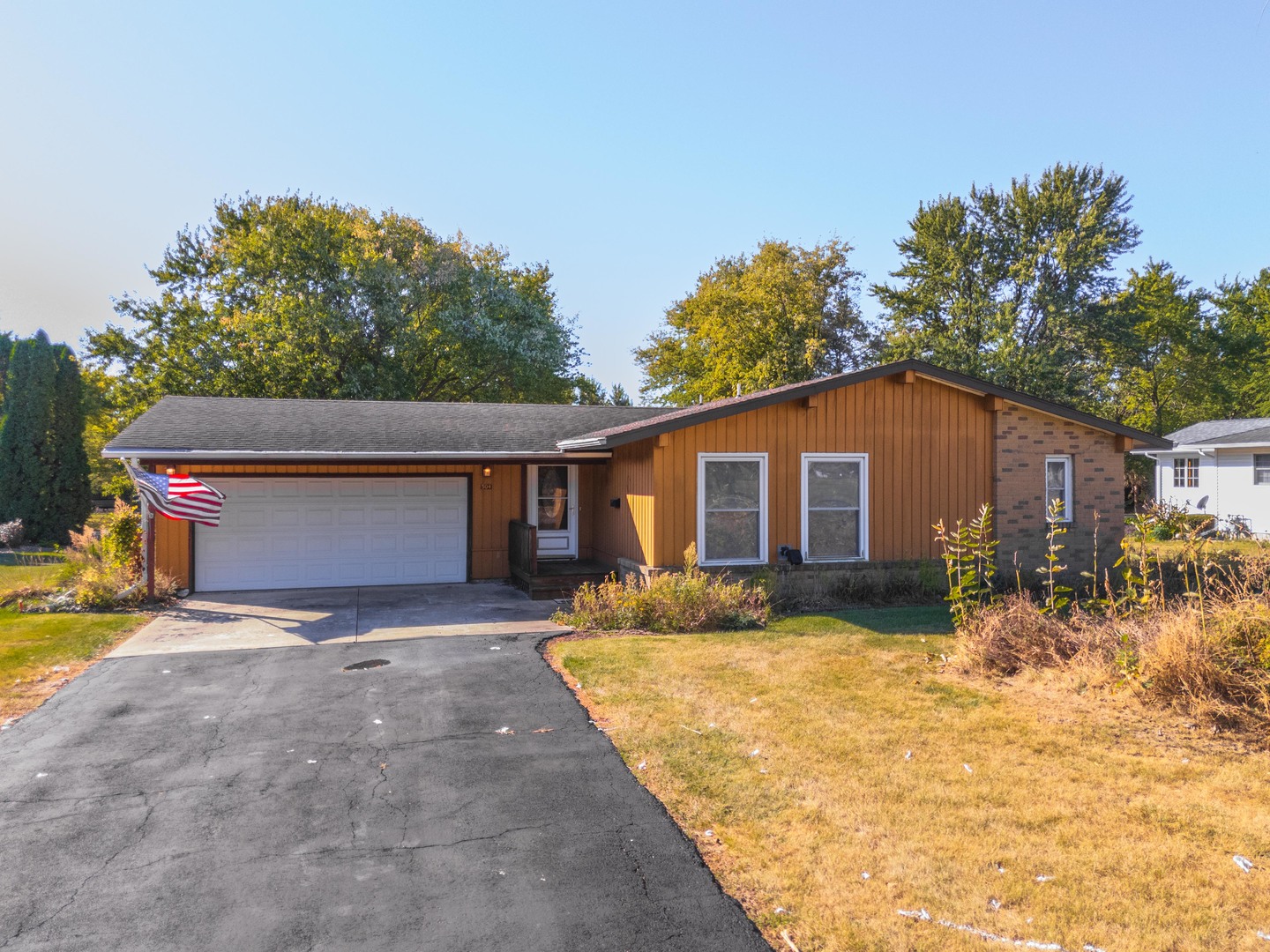 a view of a house with a yard covered with snow in front of house