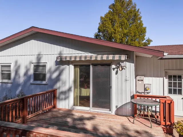 a view of a house with backyard and sitting area