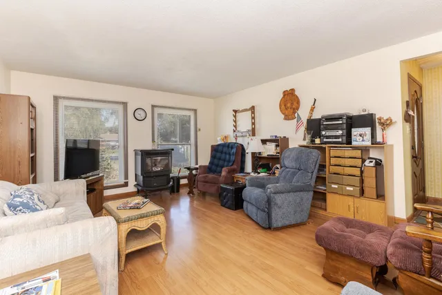 a kitchen with wooden floors and white cabinets
