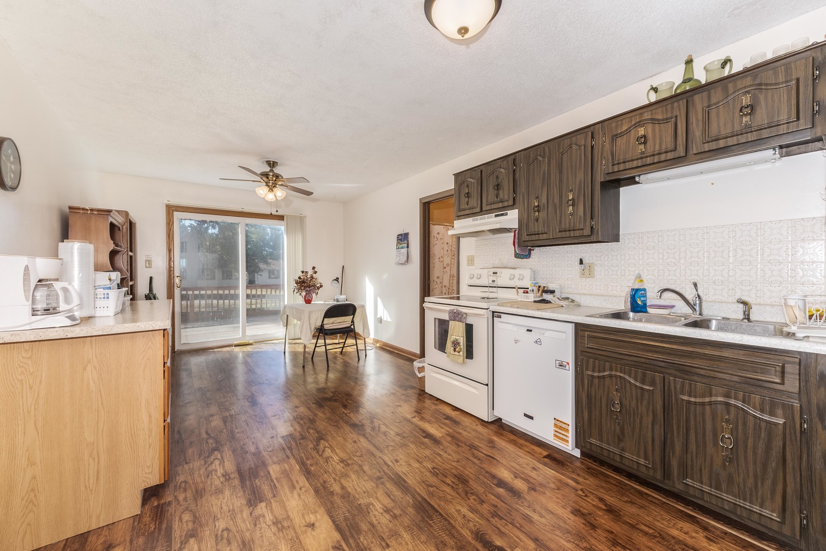 504 West Jackson Street Cullom, IL 60929 - Photo 28 of 51 a kitchen with wooden floors and white cabinets