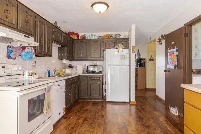 a white refrigerator freezer sitting in a kitchen