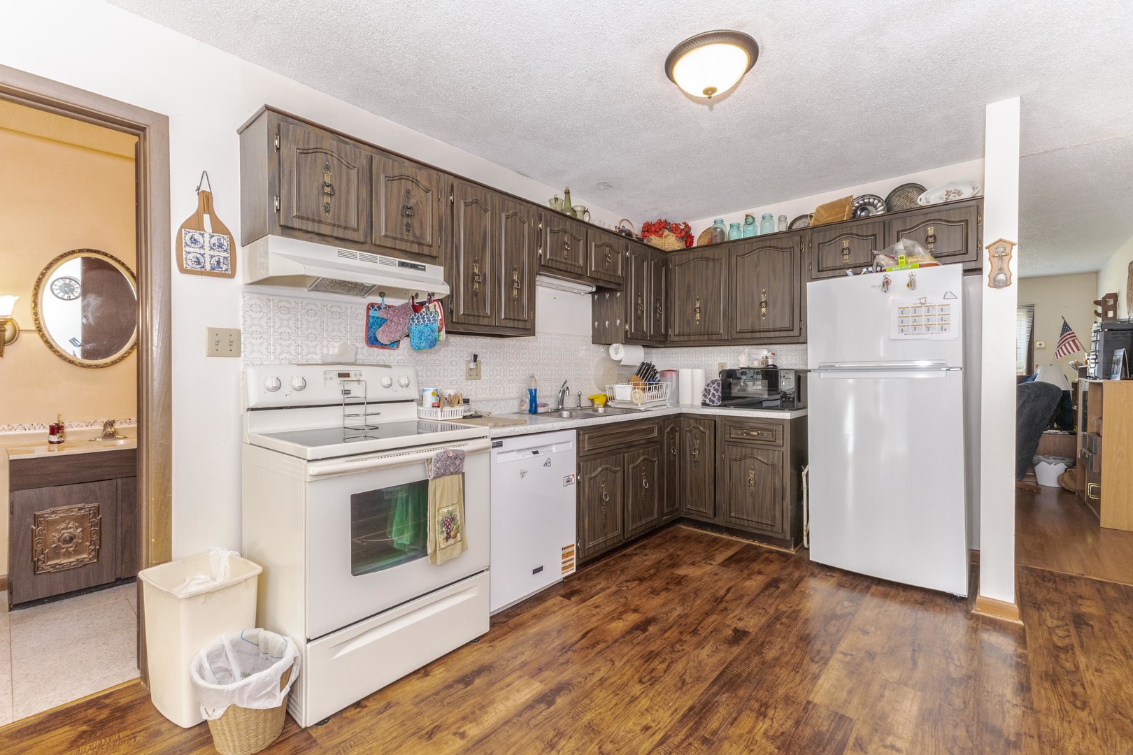 504 West Jackson Street Cullom, IL 60929 - Photo 31 of 51 a kitchen with stainless steel appliances granite countertop a stove a refrigerator and a sink with wooden floors