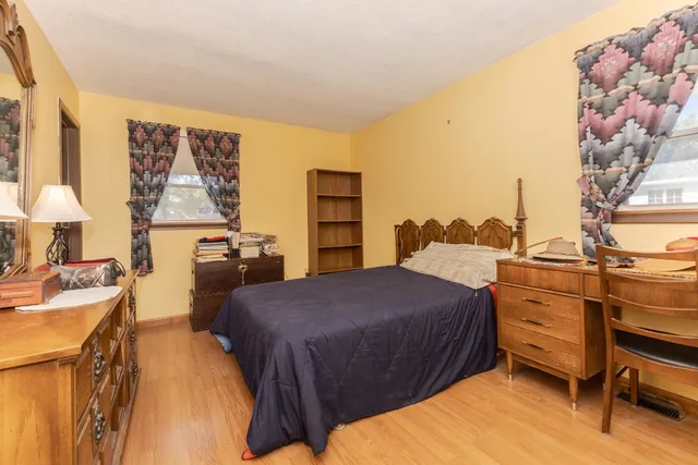 a bedroom with a bed and a dresser