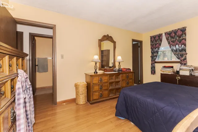 a bathroom with a toilet a sink and a mirror