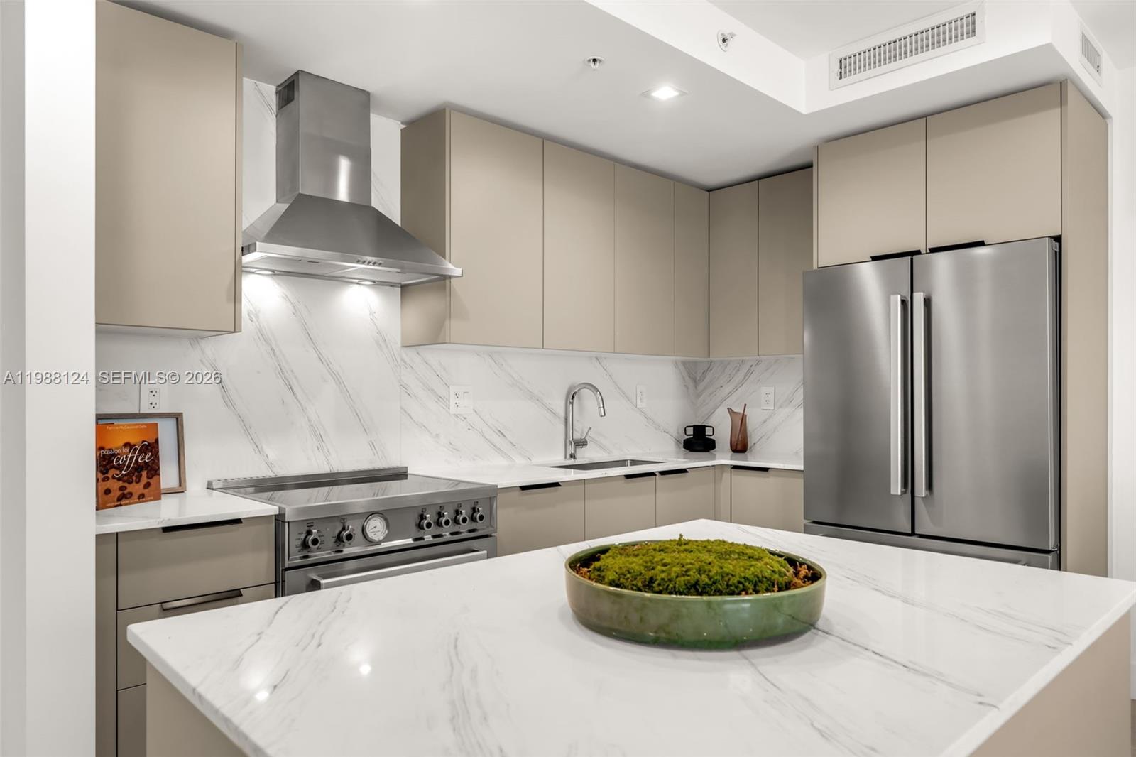 721 Southwest 11th Street, Unit E Miami, FL 33129 - Photo 11 of 26 a kitchen with a stove and a refrigerator
