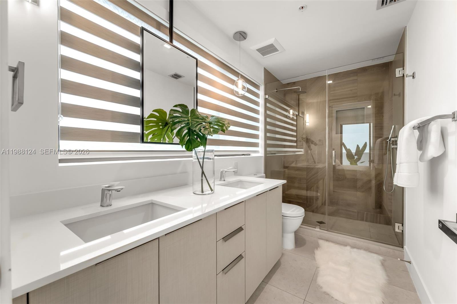 721 Southwest 11th Street, Unit E Miami, FL 33129 - Photo 13 of 26 a bathroom with a sink a toilet and shower
