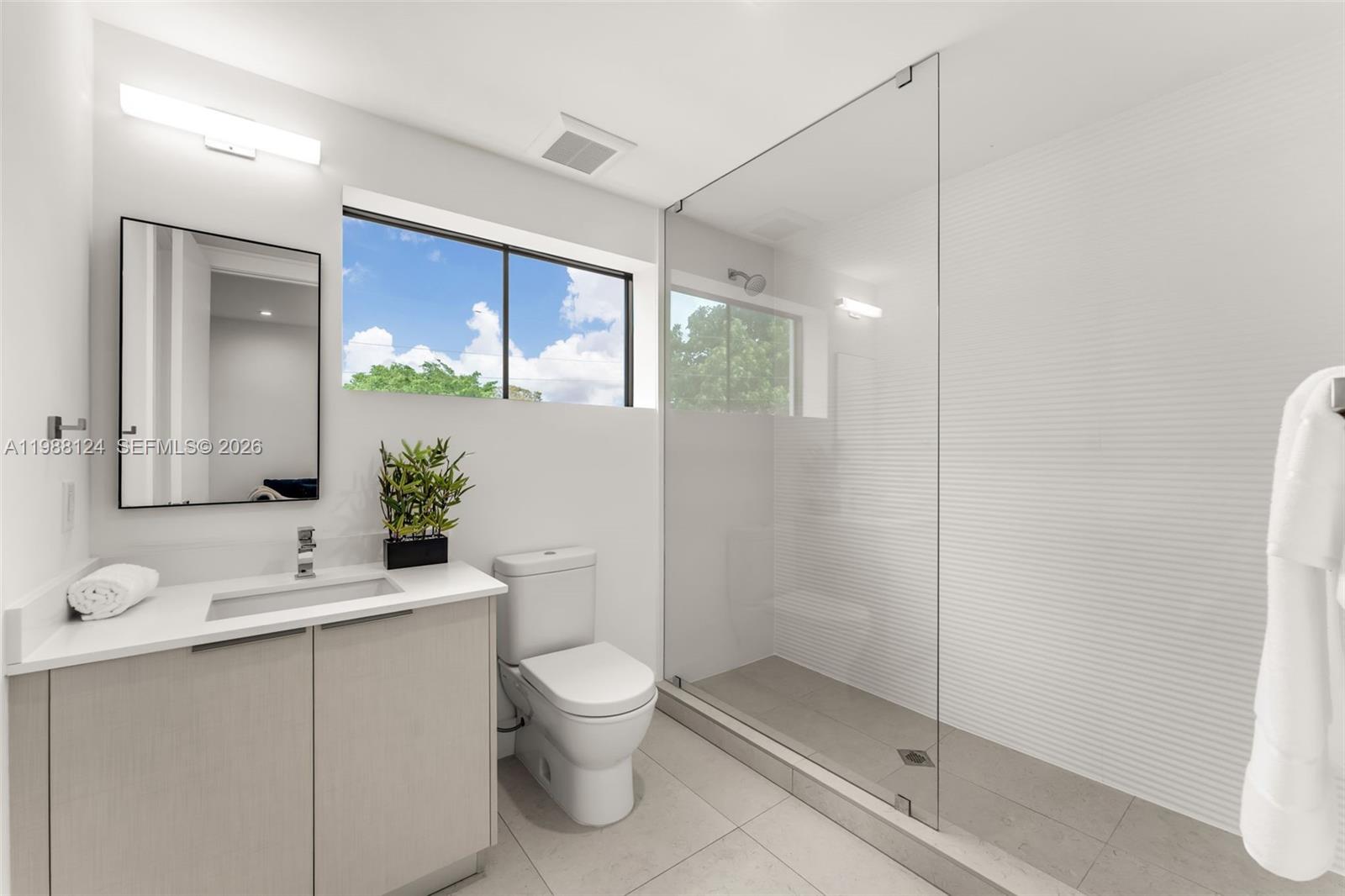 721 Southwest 11th Street, Unit E Miami, FL 33129 - Photo 15 of 26 a bathroom with a toilet sink and shower