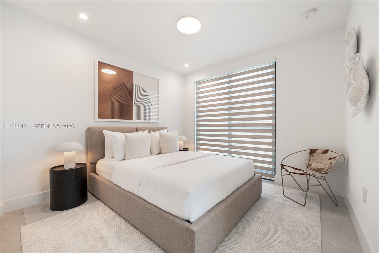 721 Southwest 11th Street, Unit E Miami, FL 33129 - Photo 17 of 26 a bedroom with a bed and chair