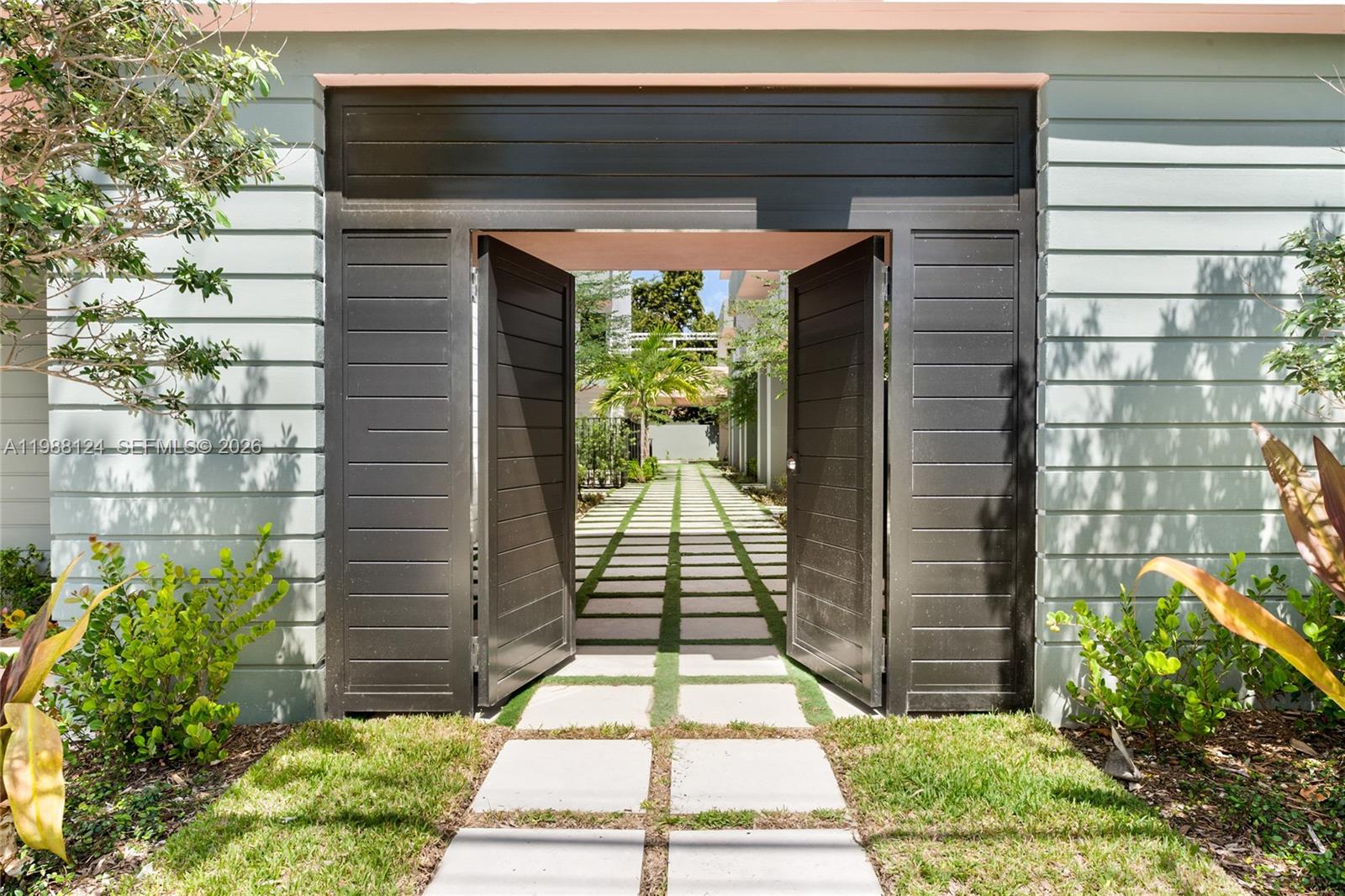 721 Southwest 11th Street, Unit E Miami, FL 33129 - Photo 2 of 26 a view of a pathway both side of house