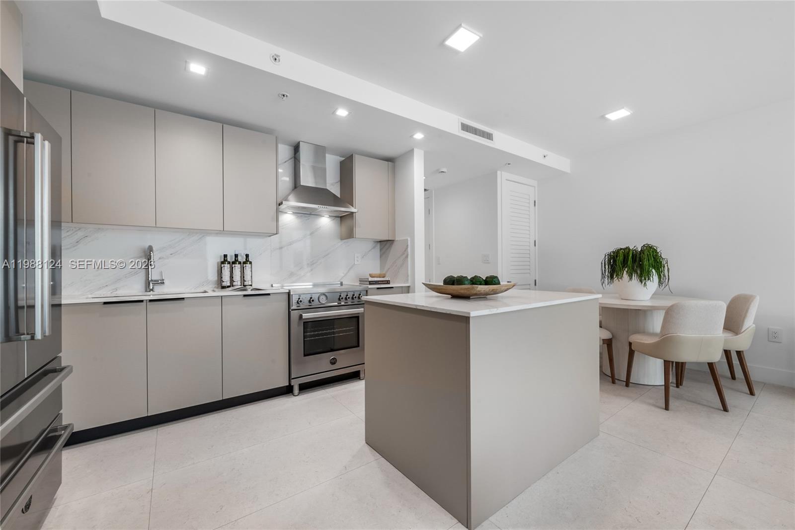 721 Southwest 11th Street, Unit E Miami, FL 33129 - Photo 10 of 26 a kitchen with a white cabinets and chairs