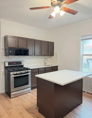 a kitchen with stainless steel appliances a stove a sink and a refrigerator