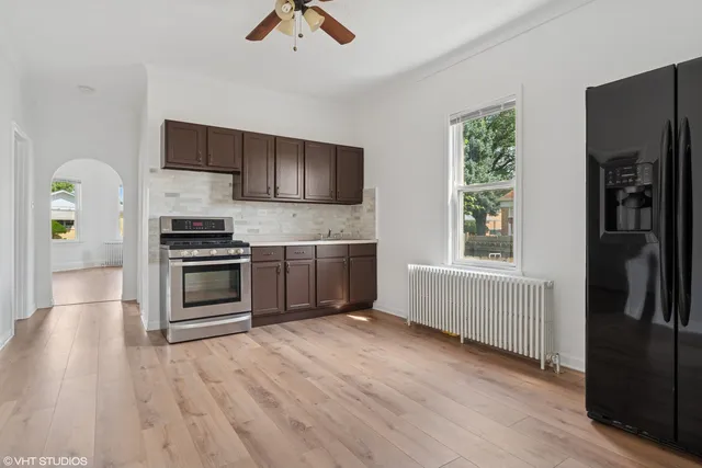 a kitchen with stainless steel appliances a refrigerator and a stove top oven