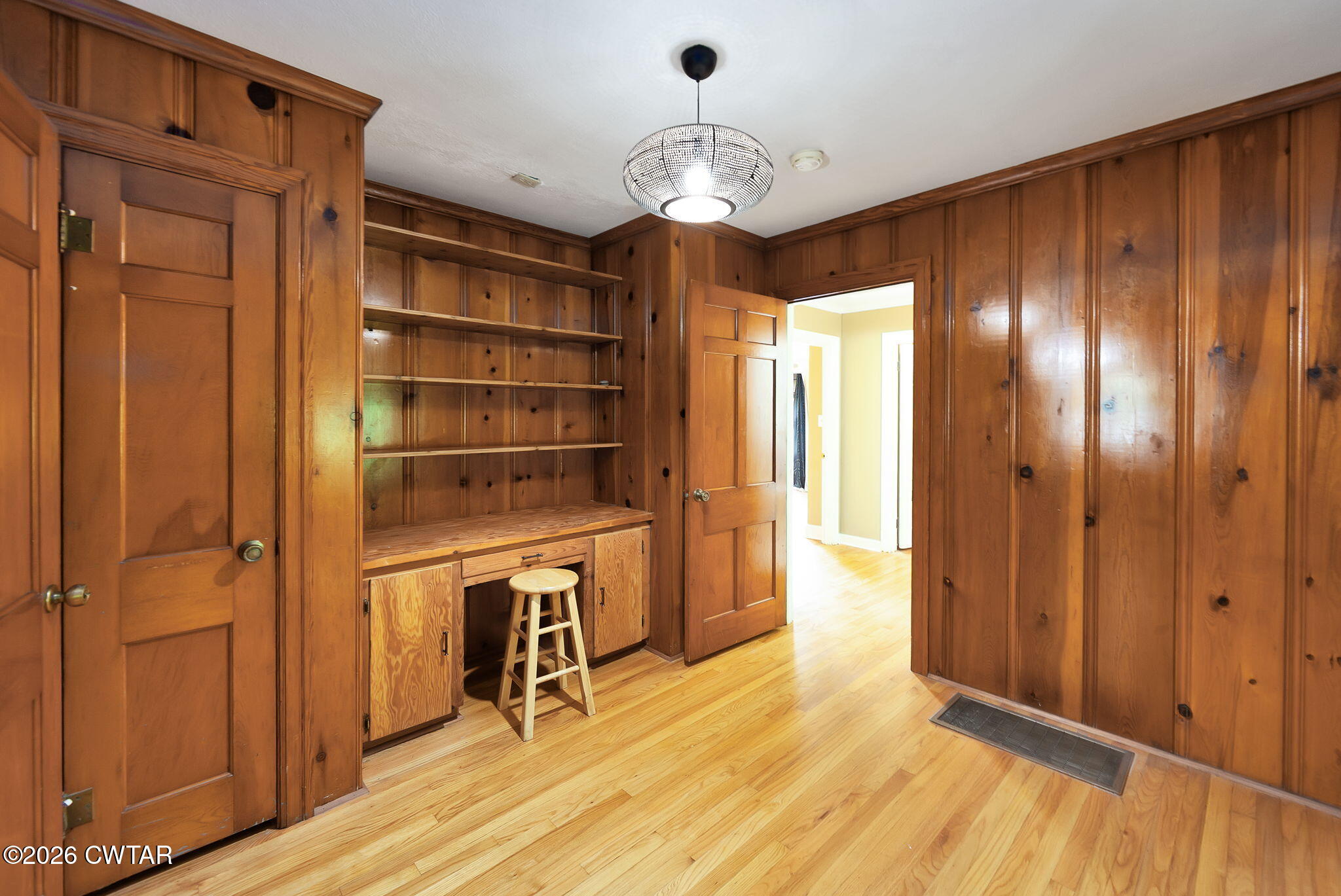 118 Radio Road Jackson, TN 38301 - Photo 7 of 22 a view of a hallway with wooden floor and a chandelier