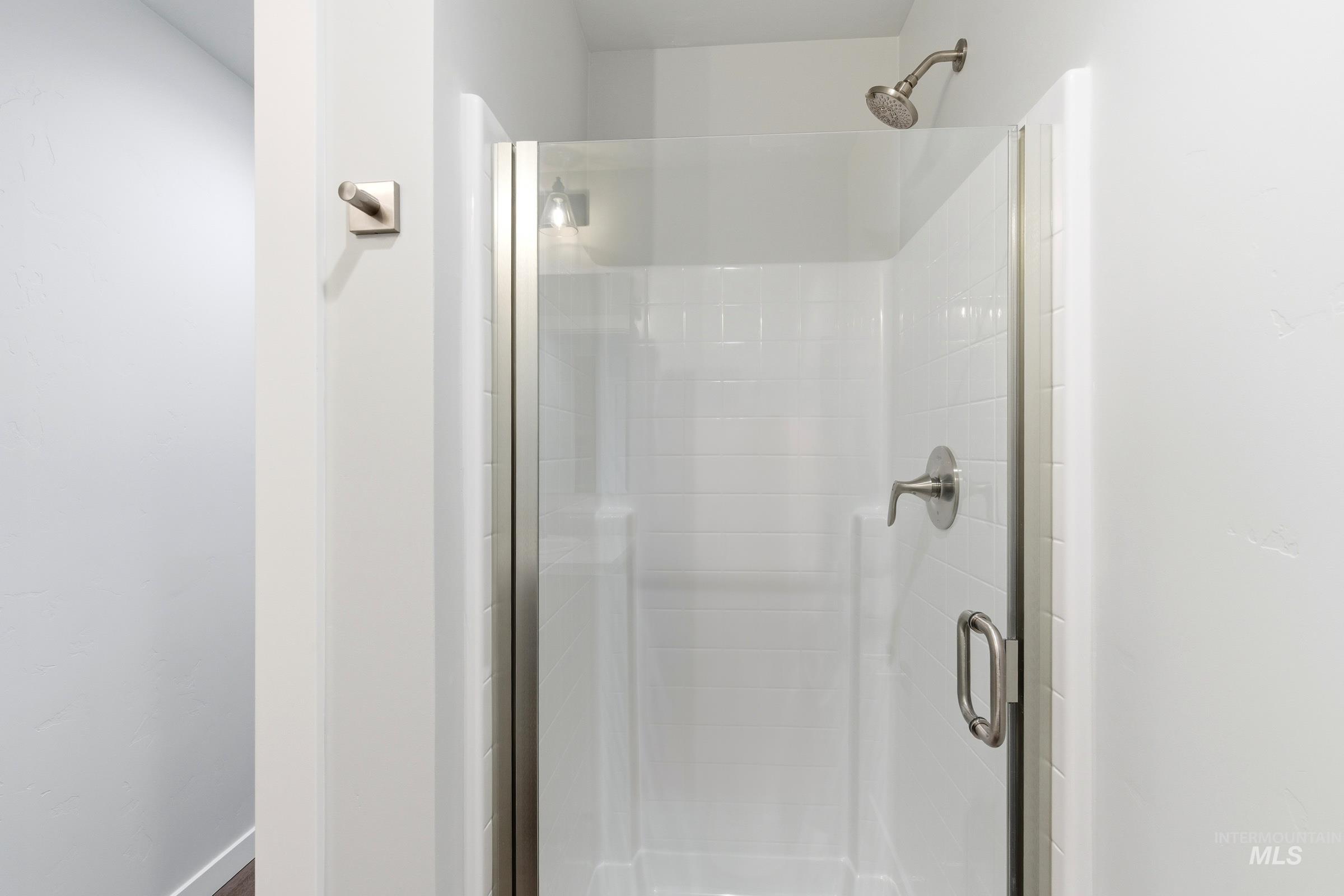 12829 Decatur Street Nampa, ID 83651 - Photo 15 of 33 Walk-in shower with clear glass enclosure and brushed nickel fixtures