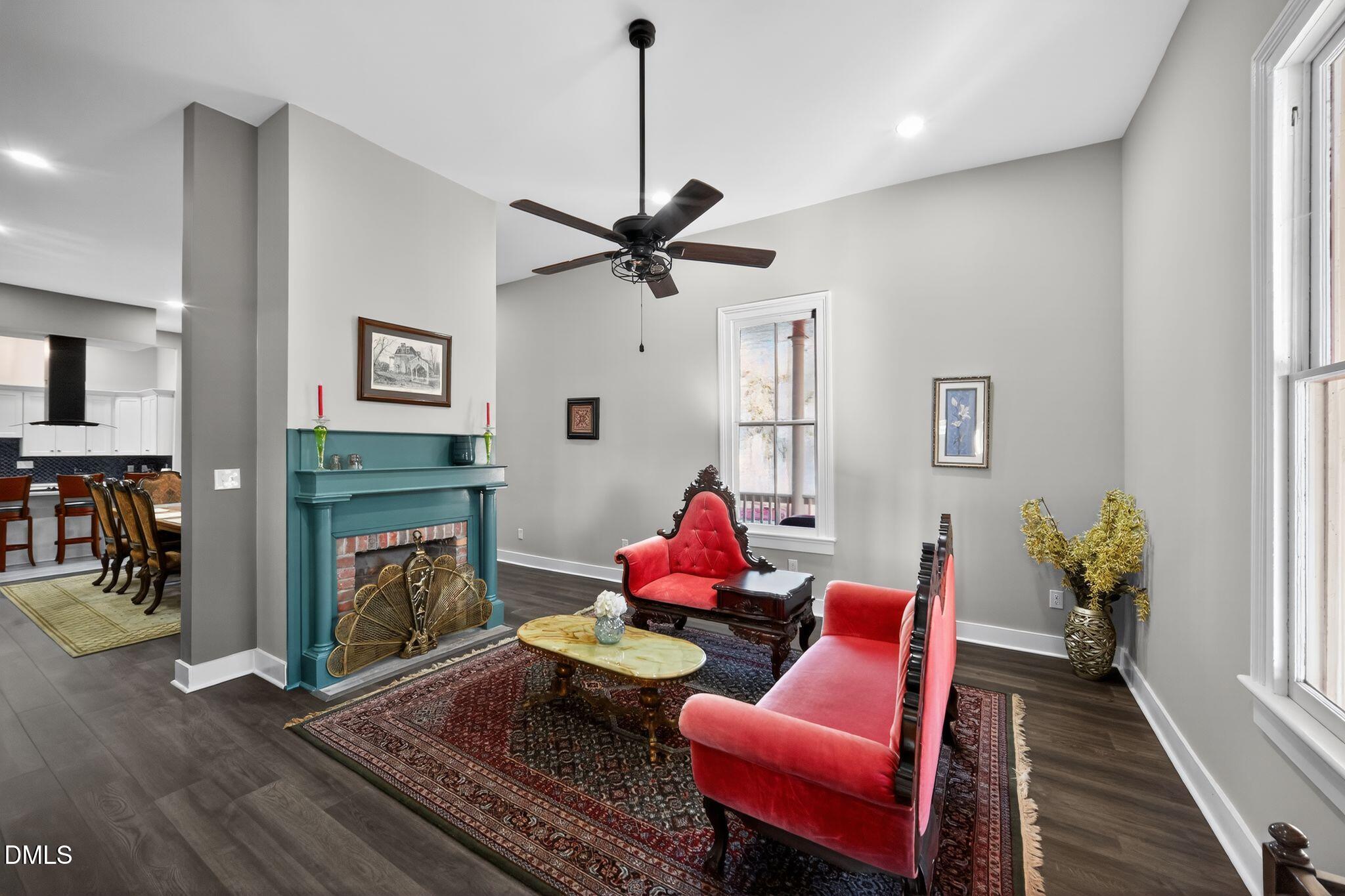 6325 Whitted Road Fuquay-Varina, NC 27526 - Photo 13 of 57 a living room with furniture a fireplace and a flat screen tv
