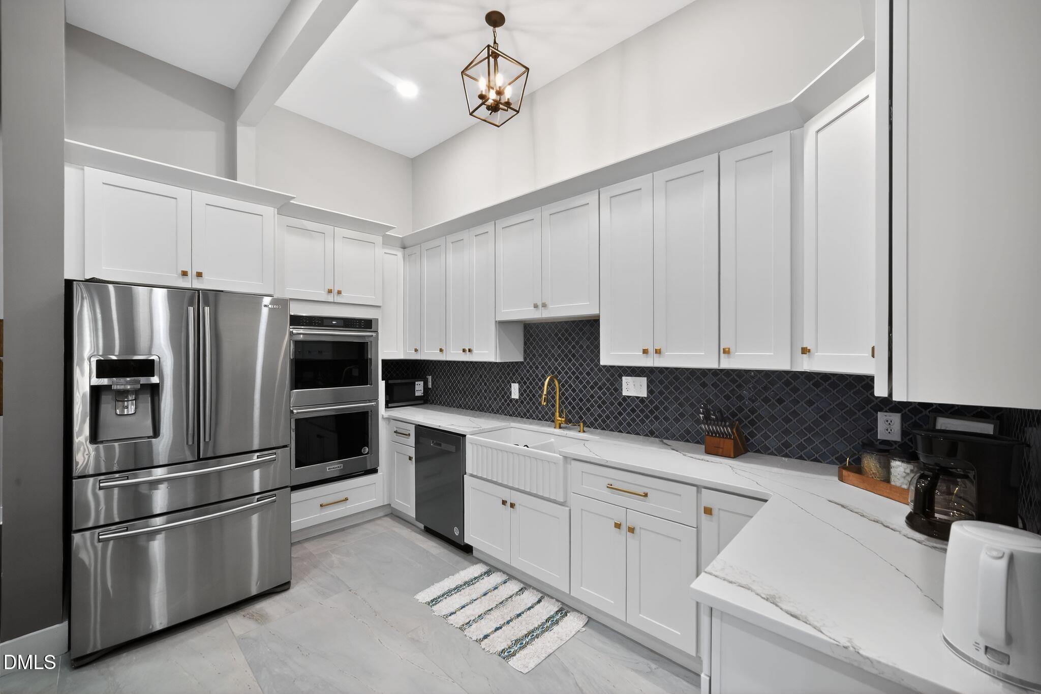 6325 Whitted Road Fuquay-Varina, NC 27526 - Photo 17 of 57 a kitchen with stainless steel appliances and white cabinets
