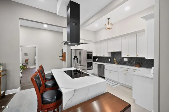a living room with furniture a fireplace and wooden floor