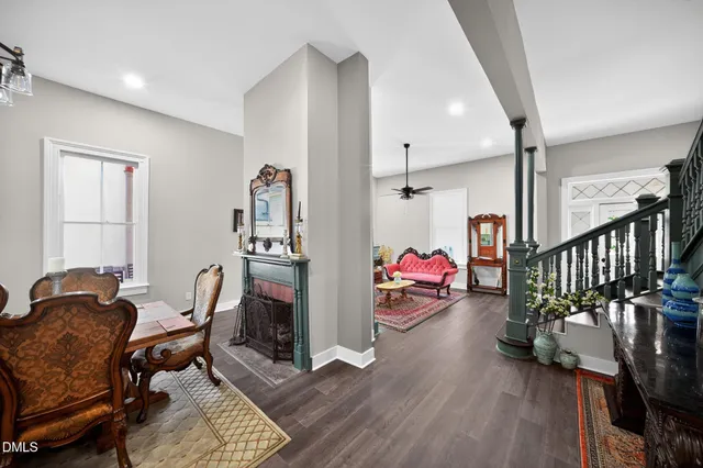 a bedroom with a large bed a flat tv screen and dresser