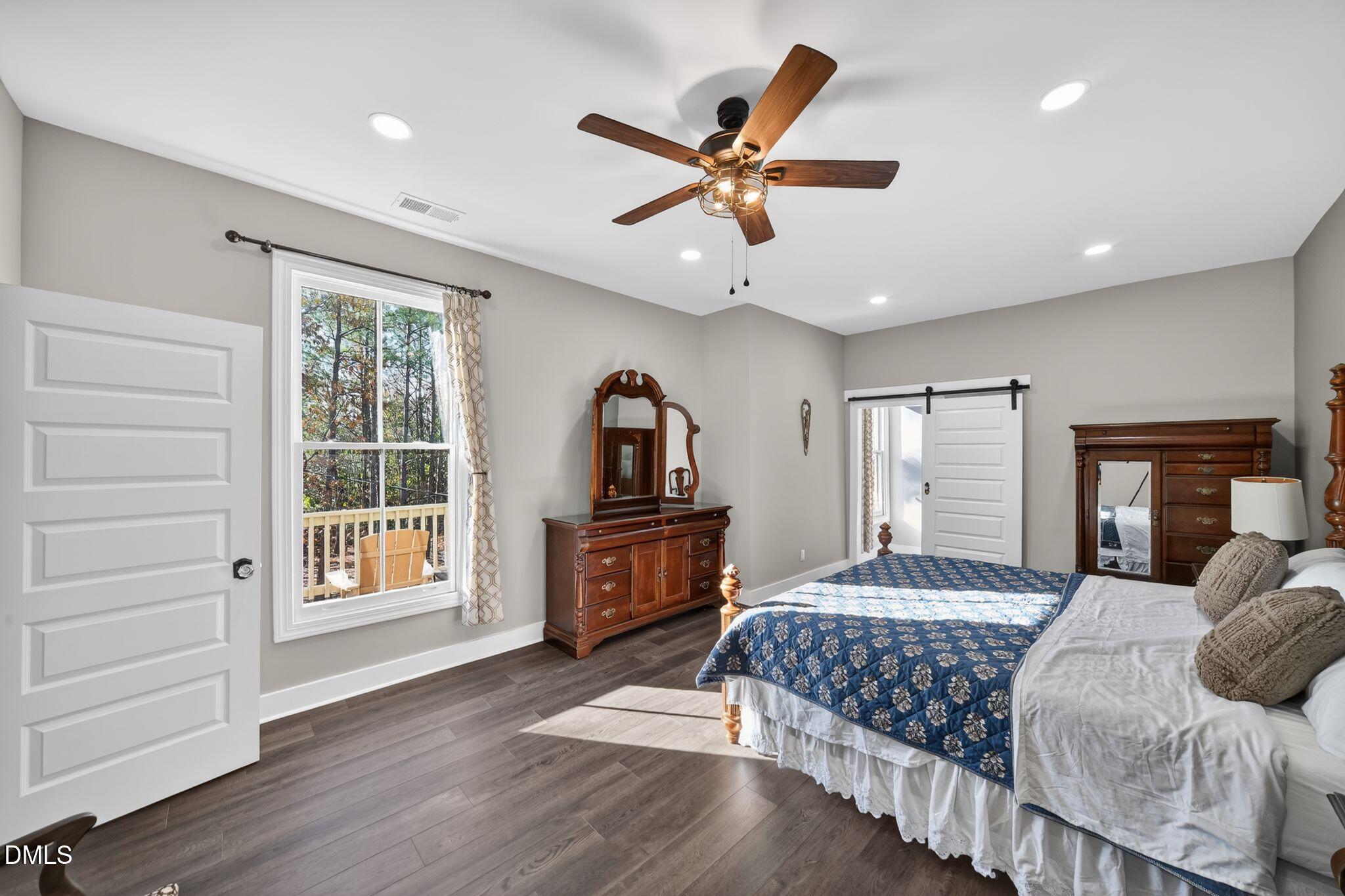 6325 Whitted Road Fuquay-Varina, NC 27526 - Photo 28 of 57 a bedroom with a large bed a flat tv screen and dresser