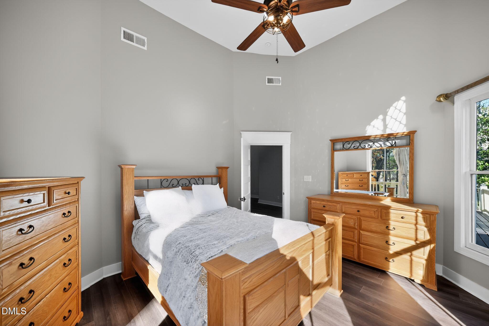 6325 Whitted Road Fuquay-Varina, NC 27526 - Photo 30 of 57 a bed room with a bed and a chandelier