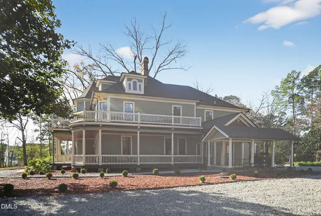a front view of a house with a yard table and chairs