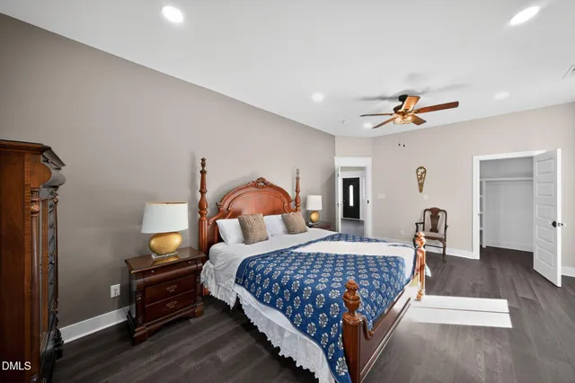 a bedroom with a bed wooden floor and window