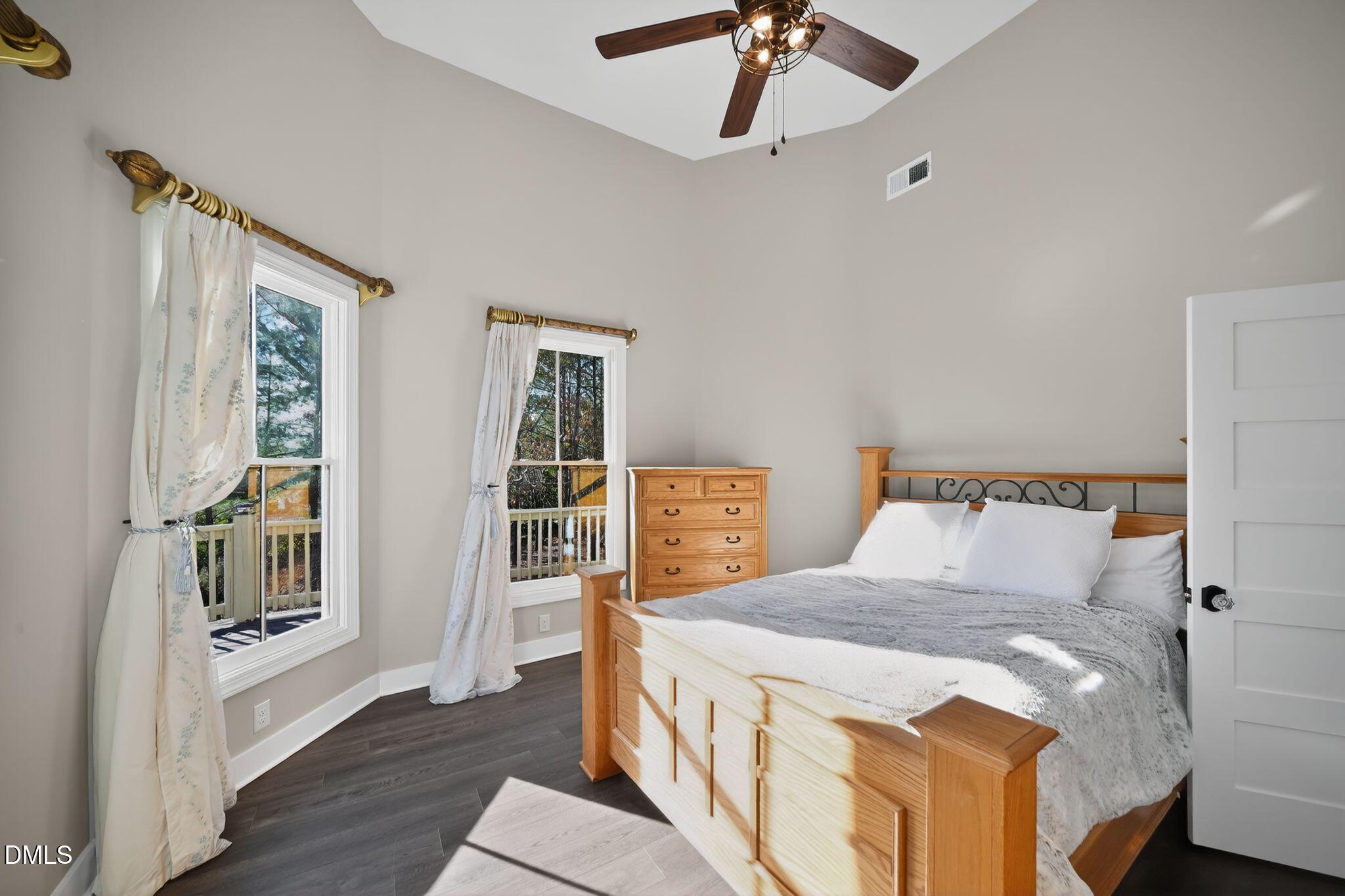 6325 Whitted Road Fuquay-Varina, NC 27526 - Photo 39 of 57 a bedroom with a bed and a chandelier