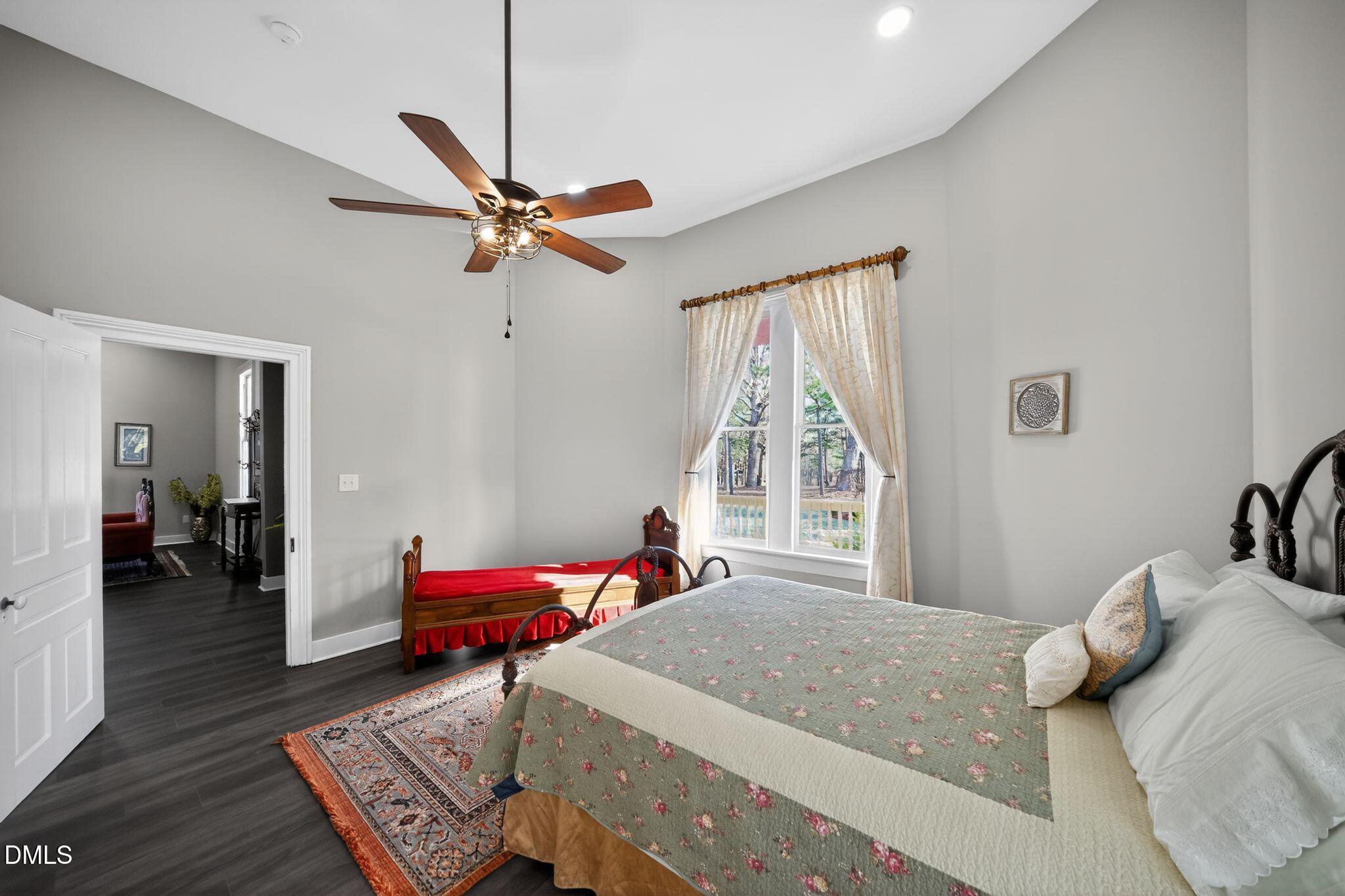 6325 Whitted Road Fuquay-Varina, NC 27526 - Photo 42 of 57 a bedroom with a bed and a chandelier