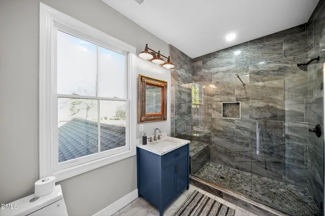 a bathroom with a shower toilet and sink