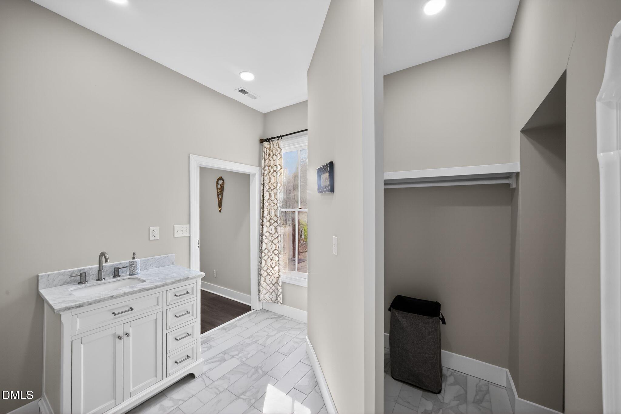 6325 Whitted Road Fuquay-Varina, NC 27526 - Photo 47 of 57 a spacious bathroom with a double vanity sink and a mirror