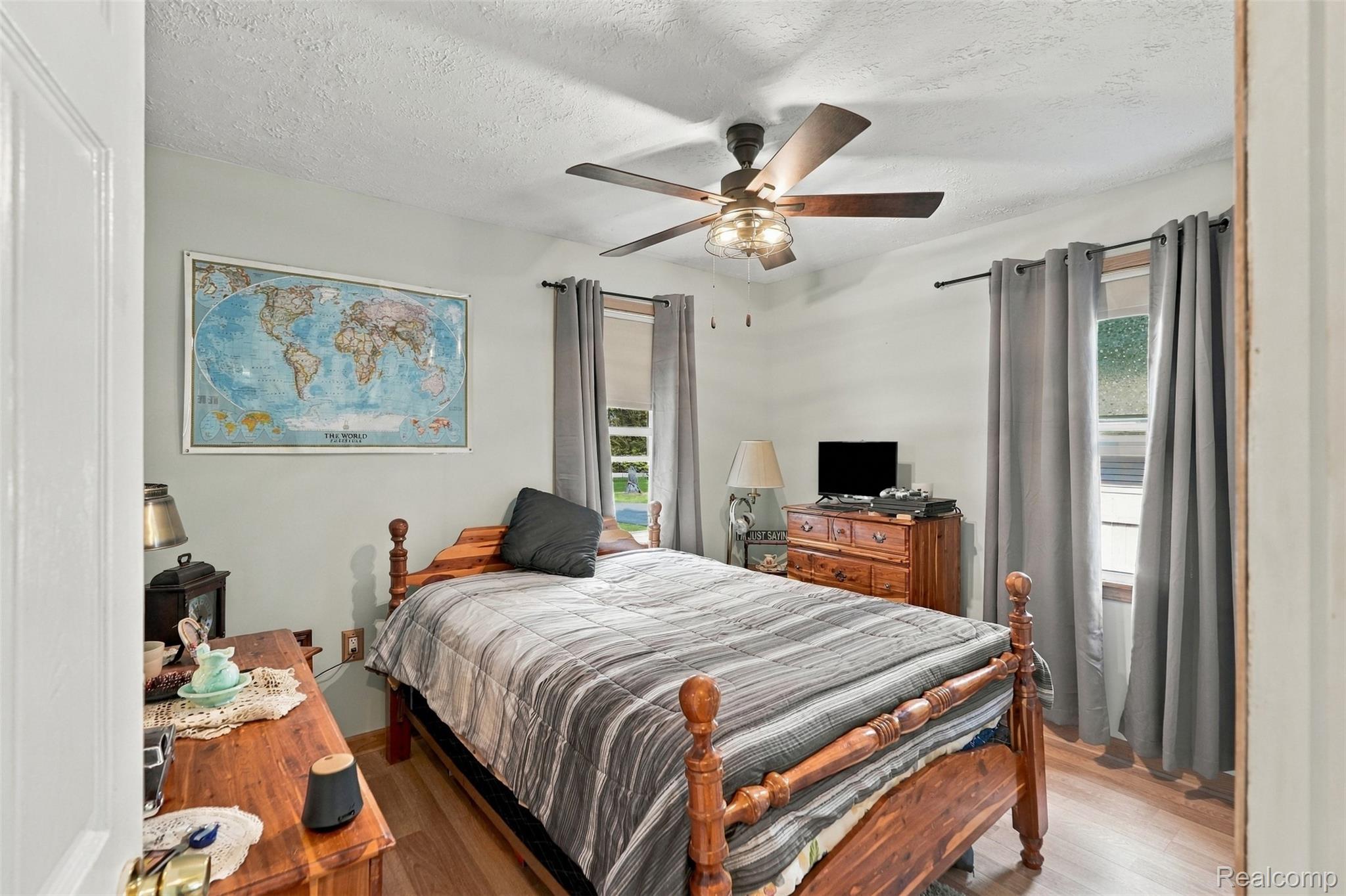 36739 Wick Road Romulus, MI 48174 - Photo 16 of 56 Wood-finish flooring, ceiling fan with integrated lighting, and two windows providing natural light