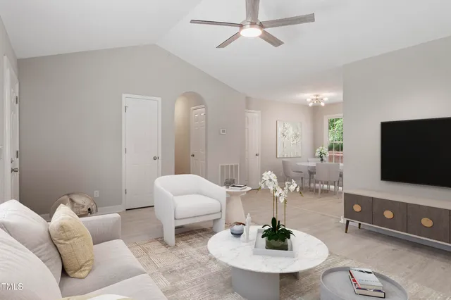 a living room with furniture a mirror and a flat screen tv