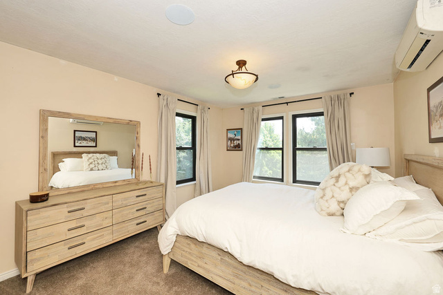3104 East High Danish Road Sandy, UT 84093 - Photo 20 of 36 2nd floor primary Bedroom featuring a ceiling-mounted light fixture, recessed ceiling speakers, and dual windows with dark trim