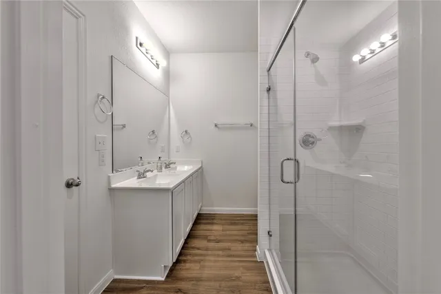 a bathroom with a sink a mirror and shower