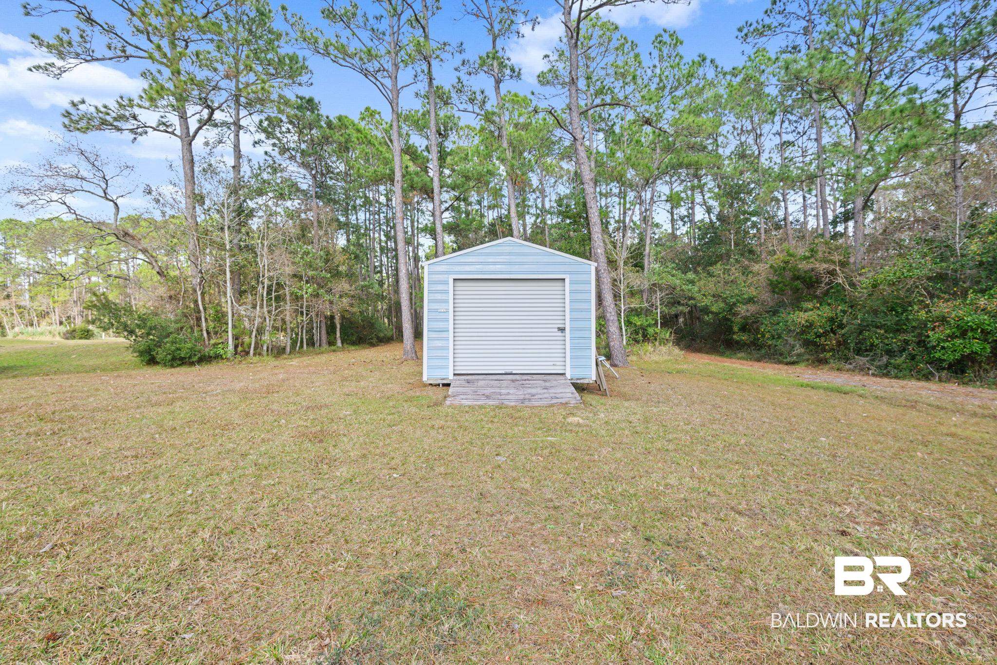 7947 Bayshore Drive Elberta, AL 36530 - Photo 8 of 26 View of green lawn with an outbuilding